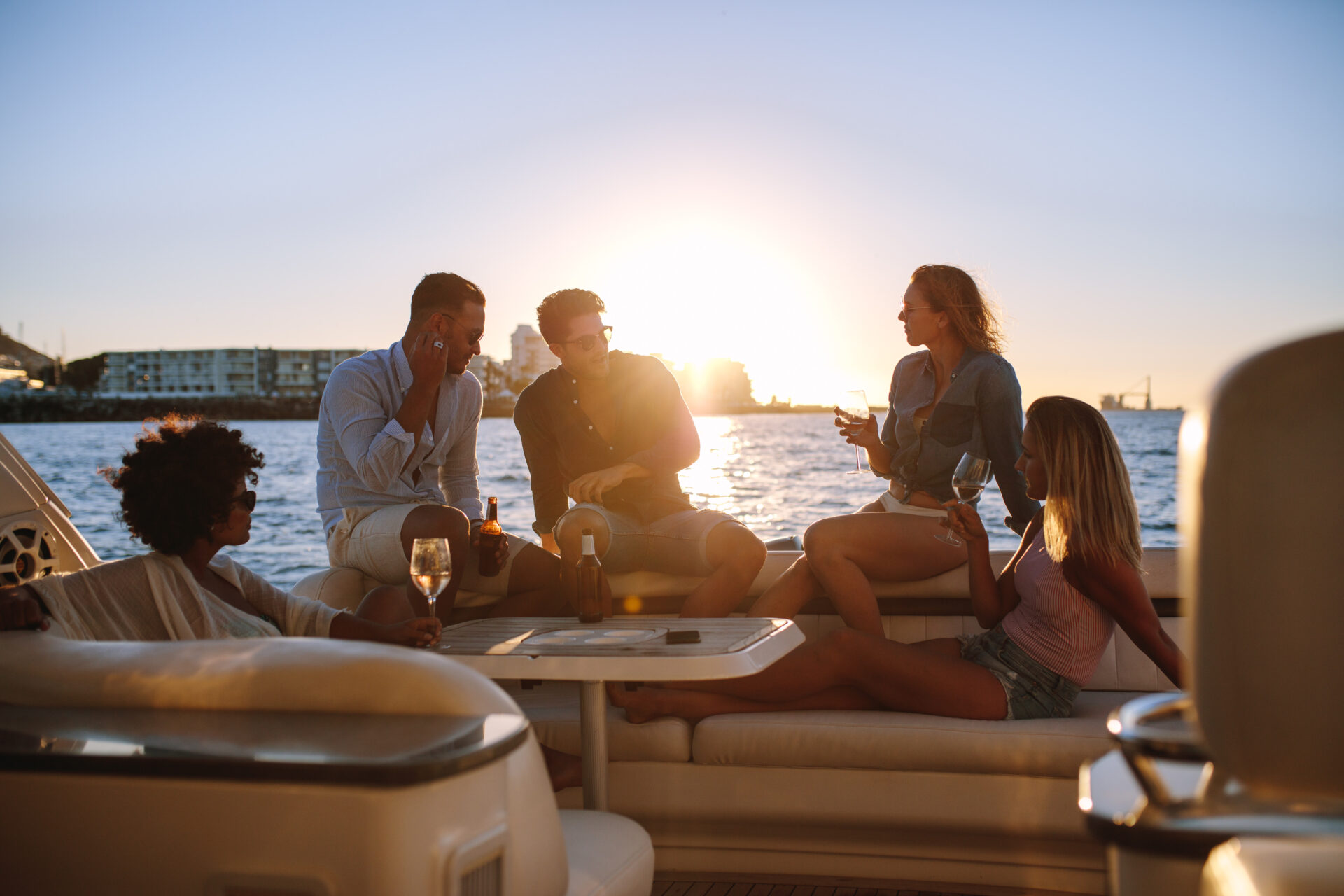 Young,Rich,Friends,Drinking,Wine,And,Beers,In,Boat,Party